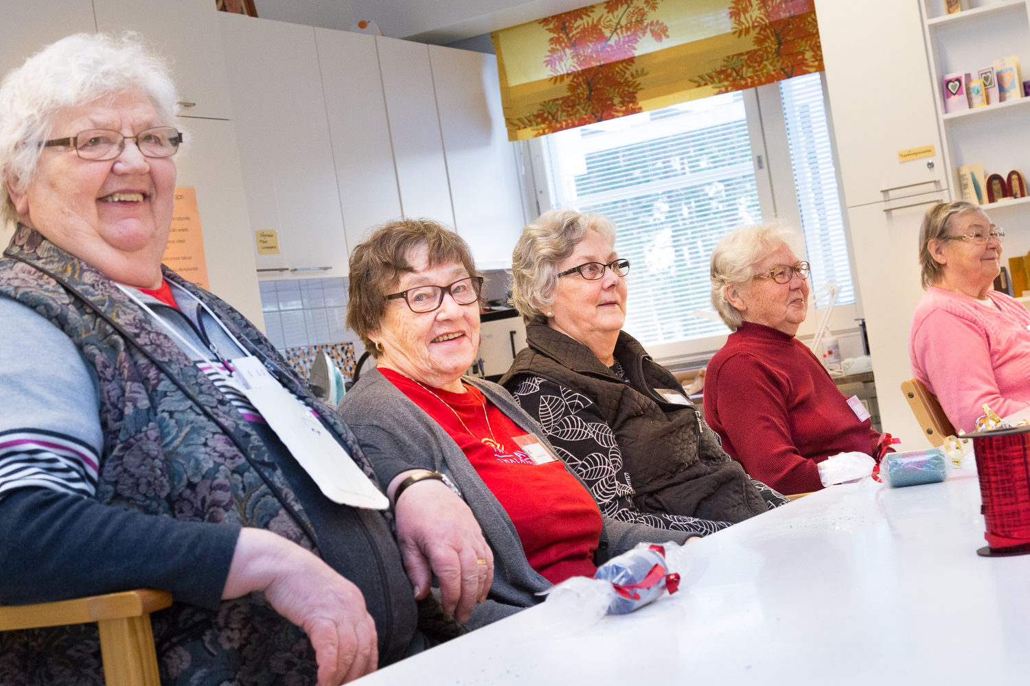 Iloisia mummoja pöydän ääressä Kunnonkodon käytössä olevalla kädentaitoverstaalla.